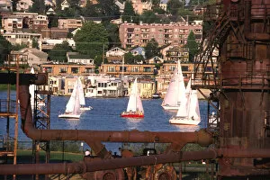 USA, Washington, Seattle. Sailboats on Lake Union pass rusty gas conversion relics