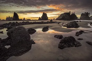 USA, Washington State, Olympic National Park. Sunrise on coast beach and rocks. Credit as