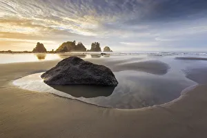 USA, Washington State, Olympic National Park. Sunrise on coast beach and rocks. Credit as