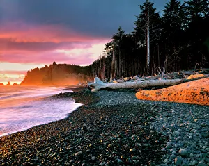 Pebble Prints: USA, Washington State, Olympic NP. Waves lap the rocky beach at sunset at Rialto Beach