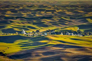 USA, Washington State, Palouse. Steptoe Village and farmland at sunset