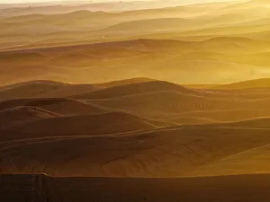 Images Dated 2017 August: USA, Washington State, Palouse Region. Sunset over rolling hills with dust in the air
