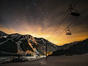Prints of USA, Washington State, Pierce County, Crystal Mountain Resort. Chairlift in front of starry dusk sky as sun sets behind mountains Images Dated 2019 January: USA, Washington State, Pierce County, Crystal Mountain Resort