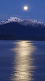USA, Washington State, Seabeck. Moon over Olympic Mountains and Hood Canal at sunrise