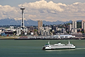 USA, Washington State, Seattle. Ferry crosses Elliot Bay under the Space Needle