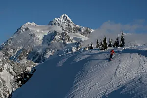 North Cascade Prints: USA, Washington State. Skier challenged by wind-drifted snow with Mount Shuksan in background