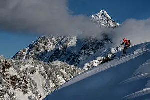 USA, Washington State. Skier enjoying powder with Mount Shuksan in background, Washington State. (MR)