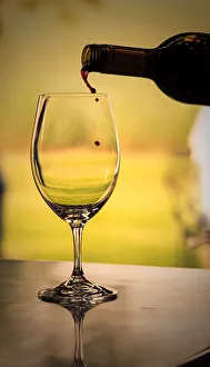 USA, Washington State, Walla Walla. Red wine backlit by the mid-day sun poured into wine USA, Washington State, Walla Walla. Red wine backlit by the mid-day sun poured into wine