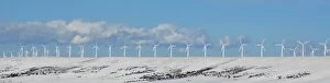 USA, Wyoming, Foote Creek Rim. Row of wind turbines in snow