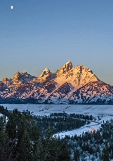 USA, Wyoming, Grand Teton National Park. Moon over landscape at sunrise. Credit as