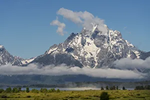 USA, Wyoming, Grand Teton National Park. Mt. Moran behind clouds after spring snowstorm