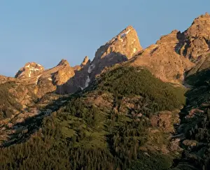 Tetons Prints: USA, Wyoming, Grand Teton NP. Forests reach almost to the flanks of the Grand Tetons