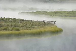 Images Dated 31st July 2007: USA, Wyoming, Green River. Morning fog settles on grassy land and curving river. Credit as