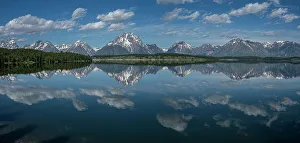 USA, Wyoming. Panoramic landscape of Teton peaks and clouds reflected in Jackson Lake, Grand Teton National Park