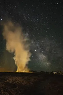 USA, Wyoming, Yellowstone National Park. Milky Way and erupting Old Faithful Geyser