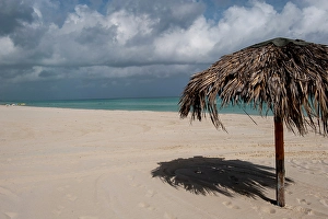 Images Dated 8th April 2024: Varadero Beach, Cuba. The empty tropical beach clad with thatched umbrellas for tourists