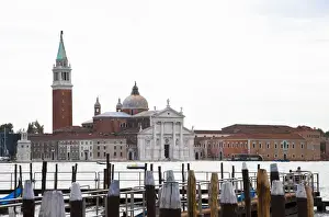 Venice, Veneto, Italy - A church can be seen across the water from a marina dock