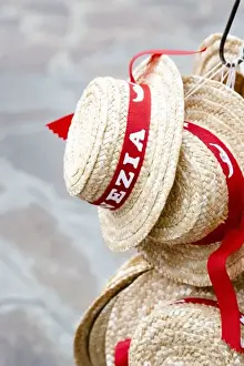 Text Prints: Venice, Veneto, Italy - Straw hats for sale to tourists are hanging from a hook