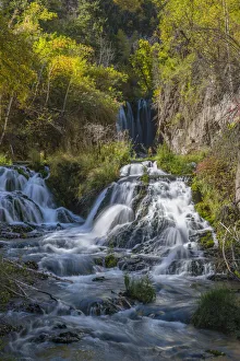 Vertical scenic of Roughlock Falls and autumn foliage, Spearfish Canyon, South Dakota
