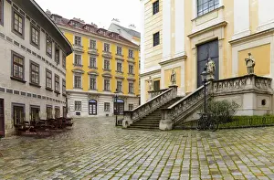 Town Square Prints: Vienna, Austria - A cobblestone town square surrounded by old world buildings. Horizontal