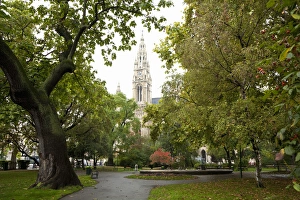Vienna, Austria - Low angle view of an ornate, old world church. Trees are framing