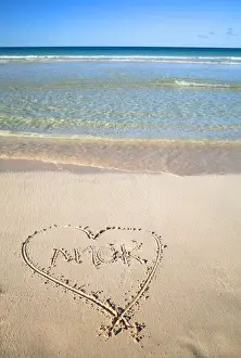 Shoreline Prints: Vieques, Puerto Rico - A heart is drawn in the sand of a beach with the word amor inside