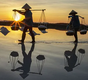 Prints of Vietnam. Doc Let Salt lake. Workers harvesting the salt. Early morning sunrise Asia Prints: Vietnam. Doc Let Salt lake. Workers harvesting the salt. Early morning sunrise