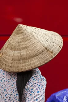Vietnam, Hanoi, woman wearing traditional hat
