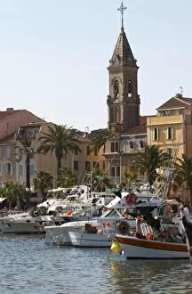 View of the harbour with fishing and leisure boats and sea front buldings Sanary