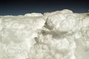 View of puffy, white clouds from an airplane