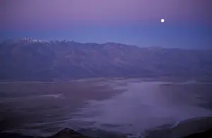 Badwater Prints: View of snow on Telescope Peak in Death Valley at sunrise with full moon descending