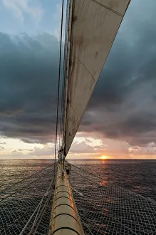 West Indies Prints: A view of the sunrise from the prow of a Star Clipper cruise ship sailing in the Caribbean near Nevis Island