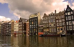 View of the unique architecture and gabled homes and coffee shop along a colorful canal