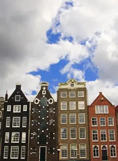 Cornice Prints: View of the unique architecture and gabled homes along a colorful canal with fluffy