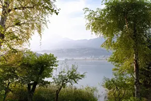 Lakefront Prints: Villach, Carinthia, Austria - A forest landscape with a lake and mountains in the background