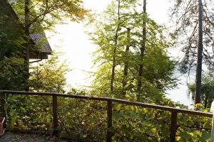 Cabin Prints: Villach, Carinthia, Austria - Looking over the railing of a wooded area with a house