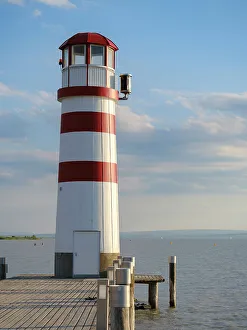 Prints of Village Podersdorf and the shore of Lake Neusiedl. The lighthouse at the harbor, the landmark of Podersdorf. Part of the UNESCO World Heritage Site. Austria, Burgenland Images Dated 2022 May: Village Podersdorf and the shore of Lake Neusiedl