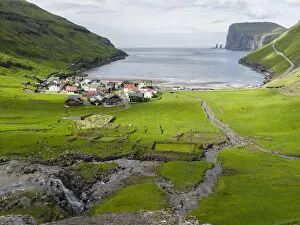 Village Tjornuvik. In the background the island Eysturoy with the iconic sea stacks Risin