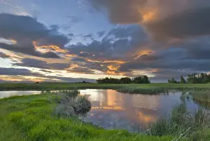 Mission Valley Prints: Vivid sunset clouds reflect into small pond at the Ninepipe Wildlife Management Area