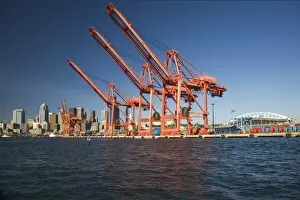WA, Seattle, Seattle skyline with shipping cranes from Elliott Bay