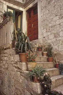 Historic Town Prints: Warm light reflects off the opposite wall to bathe this front porch area. Trogir