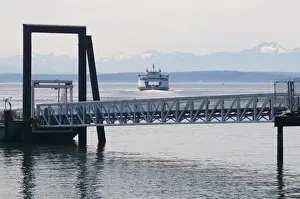 E O Reed Prints: Washington State ferry arriving at terminal in downtown Seattle. Olympic Mountains