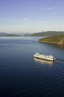 Images Dated 27th July 2007: The Washington State ferry Hyak passing by Shaw Island in the evening light with Mt