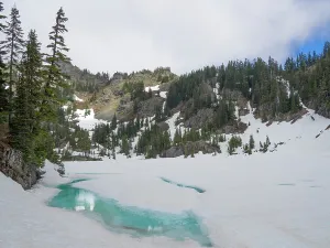 Washington State, USA. Central Cascades, Mount Baker Snoqualmie National Forest, Lake Lilliam, partially melted out from winter snow