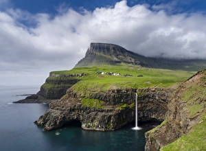Lonely Prints: The waterfall near Gasadalur, one of the landmarks of Faroe Islands. The island Vagar