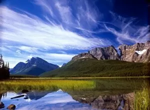 The still waters of Waterfowl Lake make a perfect reflection of a dramatic blue sky