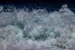 Waves foaming and bubbling when they hammer the sandy beach at Sunset Beach