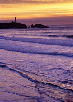Images Dated 19th September 2006: Waves wash in by the Yaquina Head Lighthouse at sunset, near Newport, on the Oregon Coast
