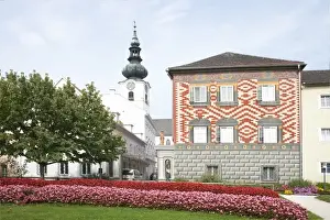 Fragrant Prints: Wels, Upper Austria, Austria - Rows of red and pink flowers border a lawn in front of a building