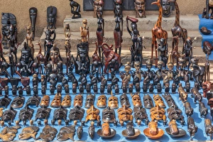 Carving Prints: West Africa, The Gambia, Banjul. Wooden masks, animals, and other crafts for sale